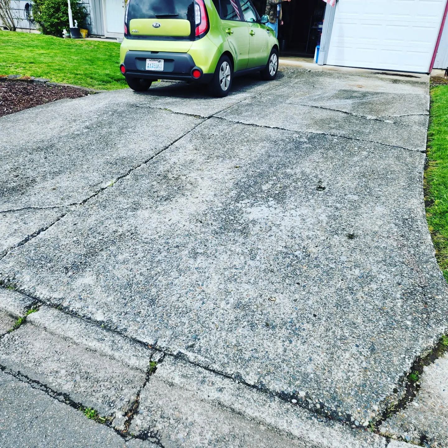 Cracked and heaved residential driveway before replacement