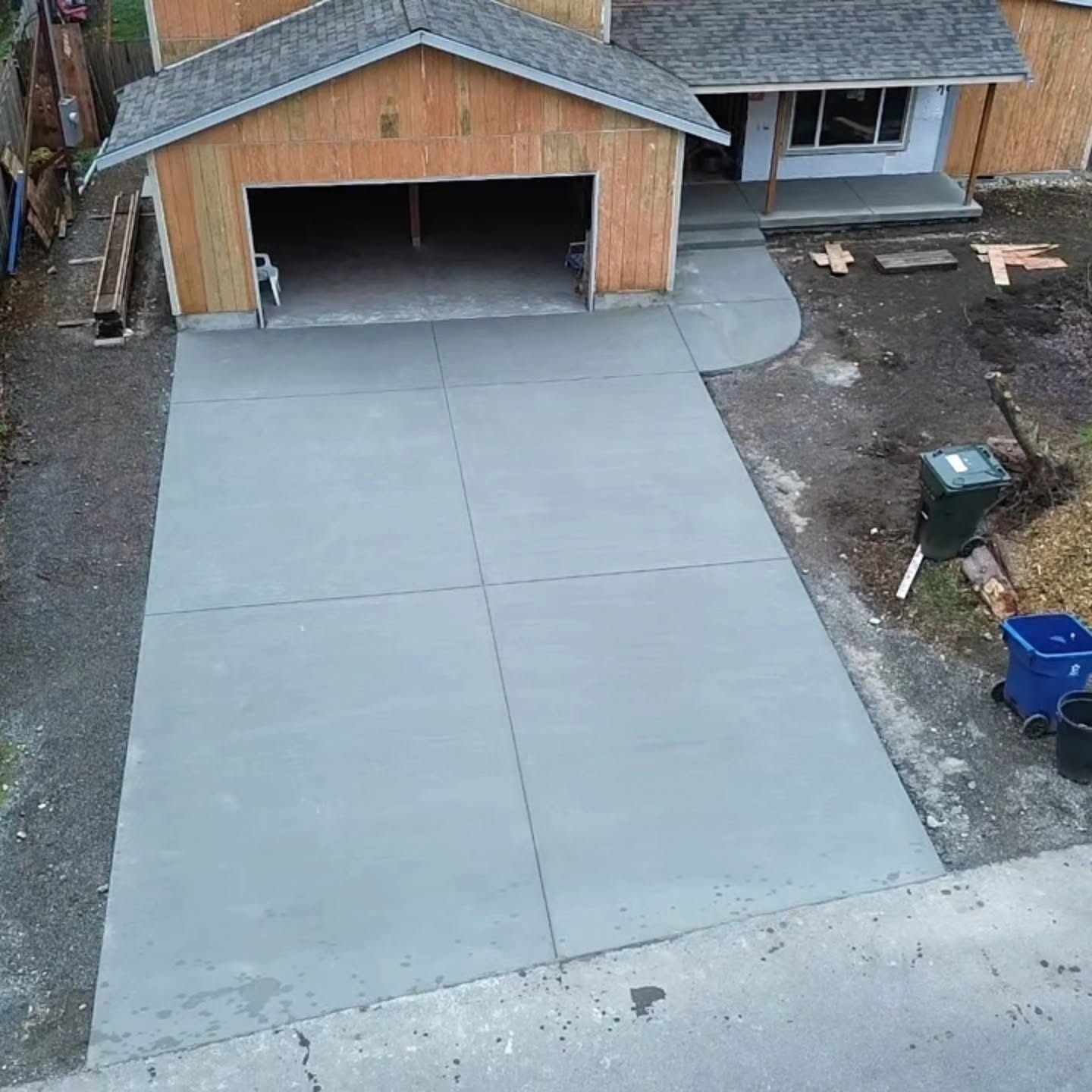 Finished residential driveway overhead view with clean concrete