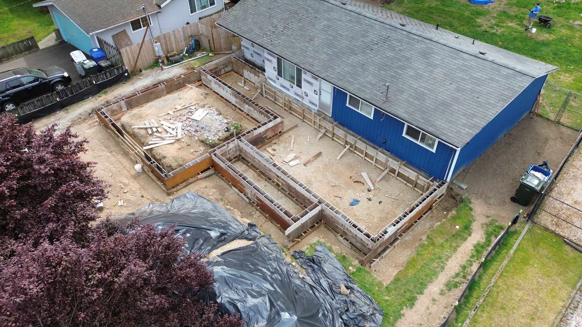 Ground-level fresh foundation pour with caution tape