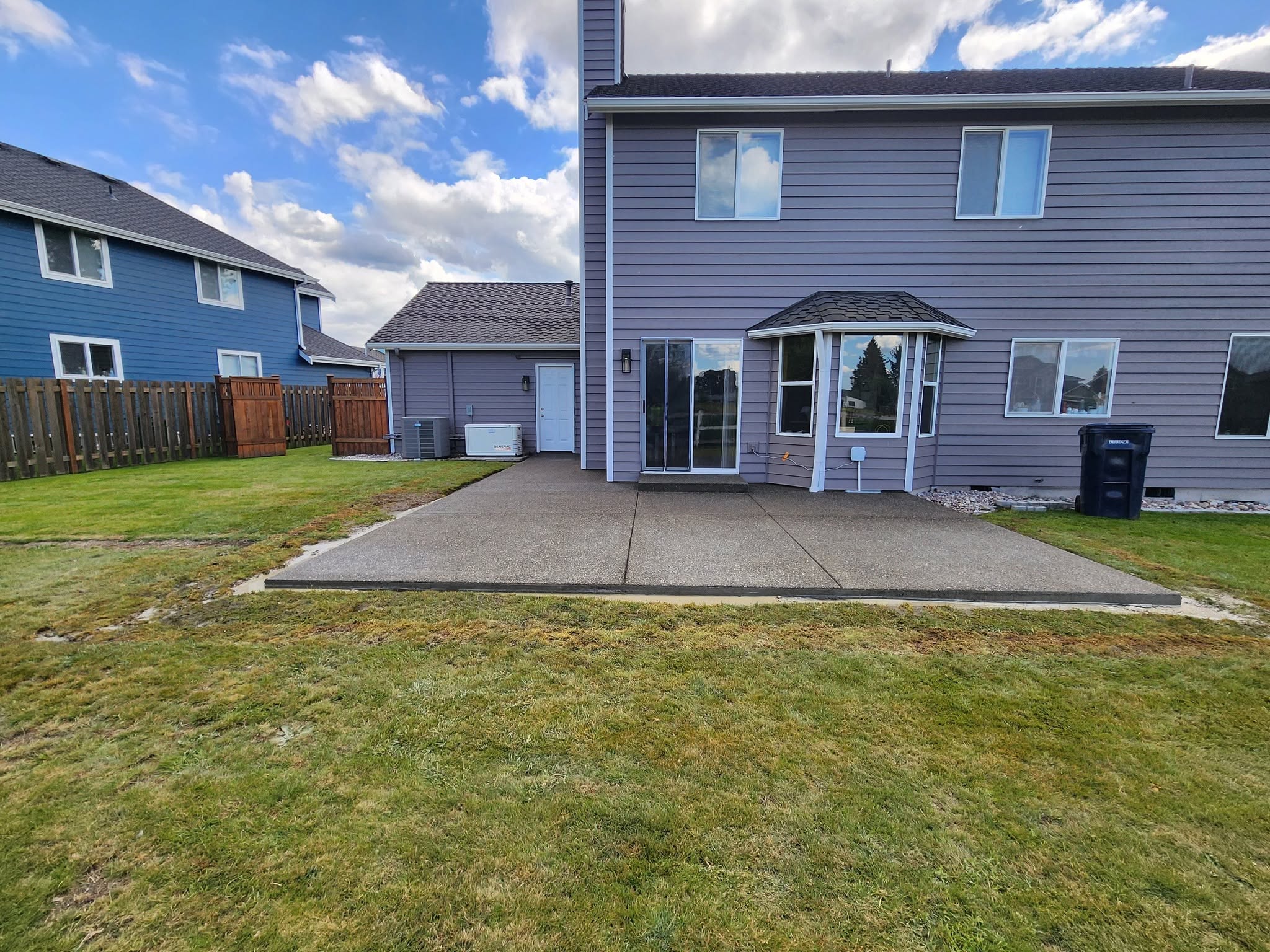Exposed aggregate patio in suburban backyard