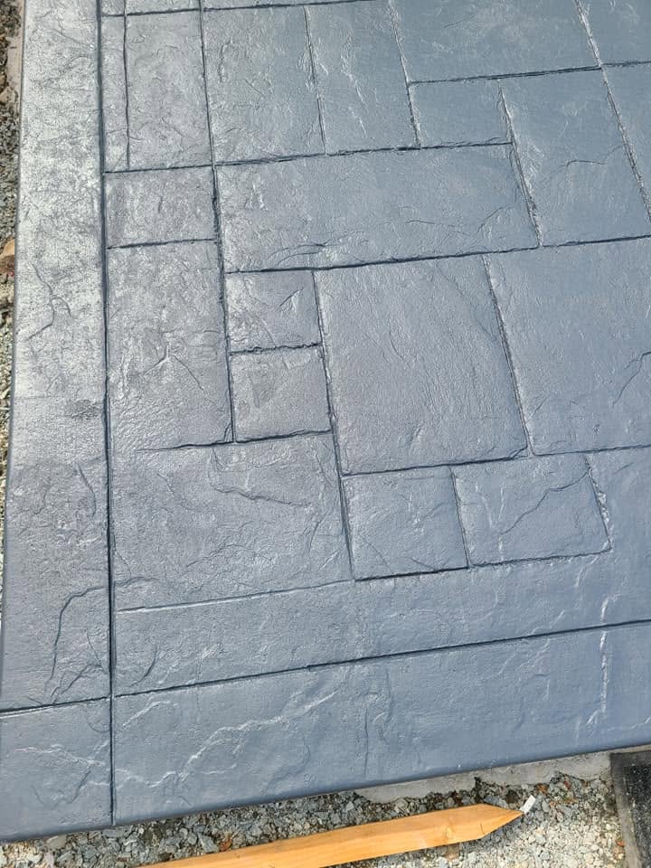 Slate ashlar stamped concrete close-up in dark blue-gray