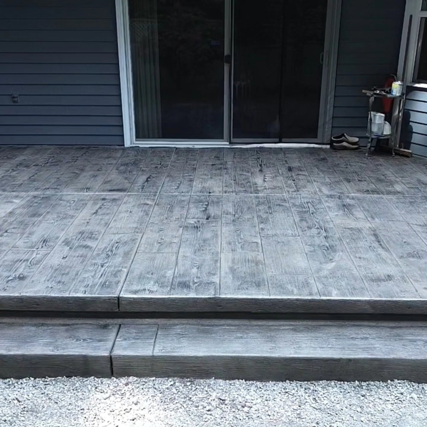 Wood-grain stamped concrete patio with steps